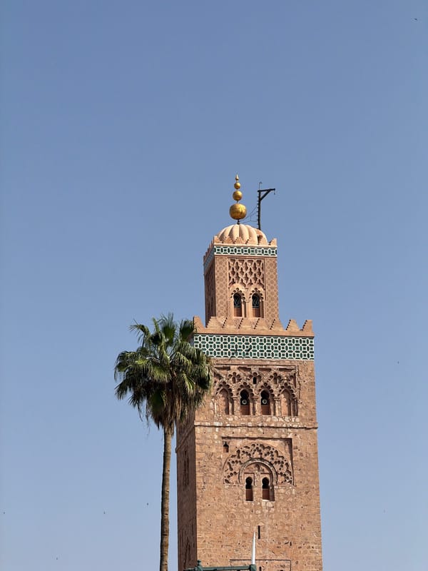 Historic minaret tower documented in Marrakesh under clear skies