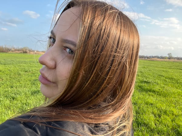 Rural moments: person resting in field, chicken wandering outdoors