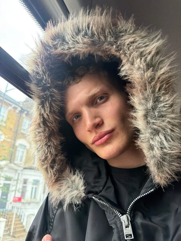 Young person in fur-trimmed hood photographed in London selfie