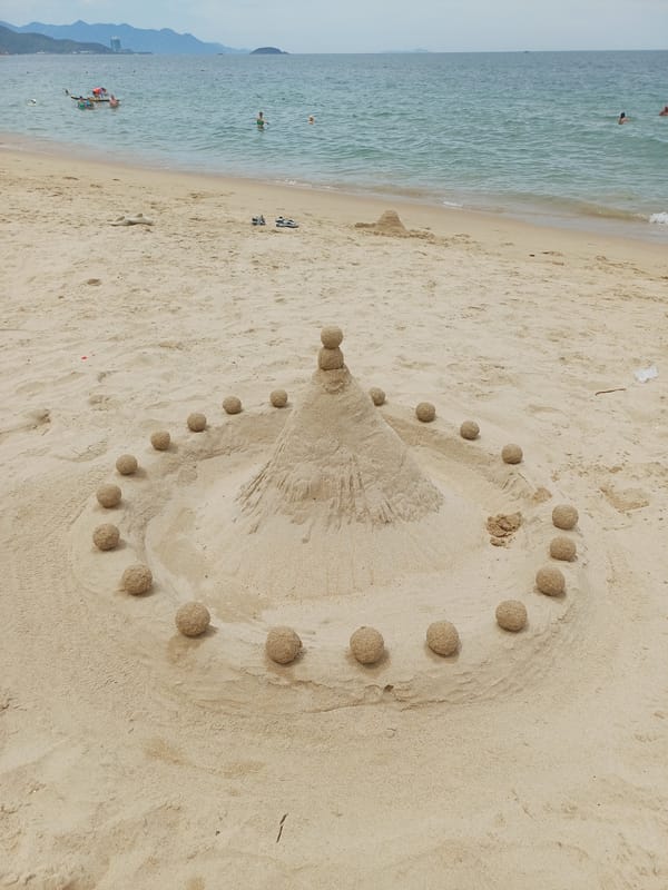 Geometric sandcastle with stacked spheres on Nha Trang beach