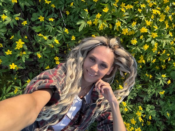 Woman photographed exploring Rusanovo countryside and town during spring afternoon