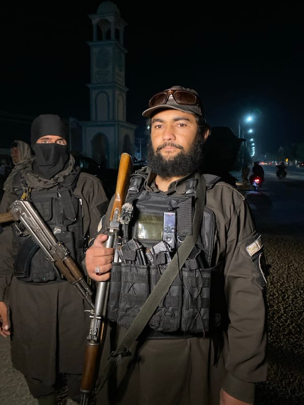 Armed personnel conduct nighttime security operation in Kandahar