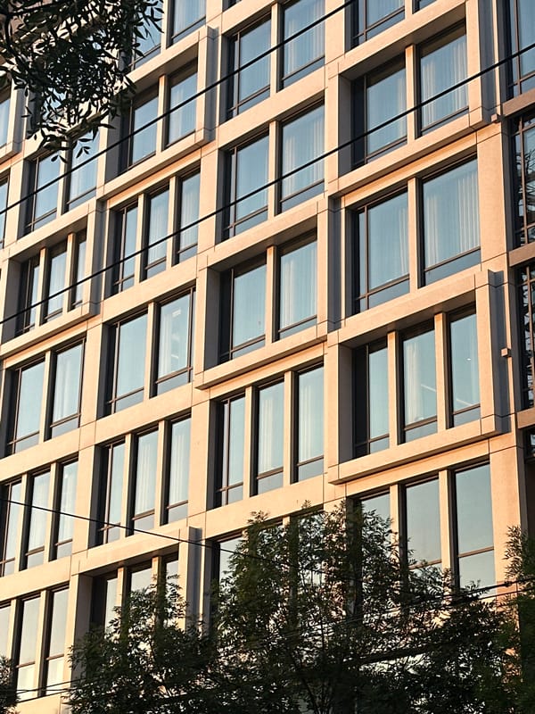 Modern building facade in Belgrade, stone and glass grid