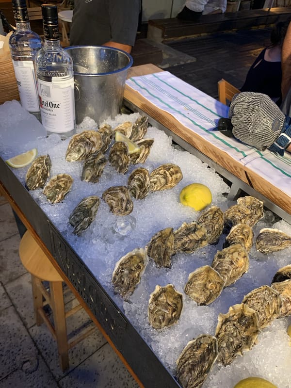 Outdoor dining venue with food, drinks, music documented in Tel Aviv