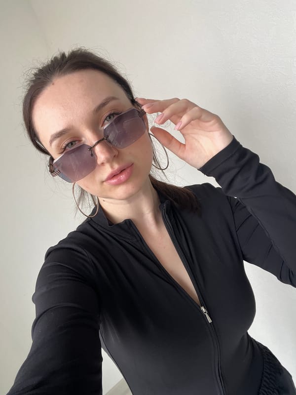 Woman in sunglasses photographed from below in Tyumen
