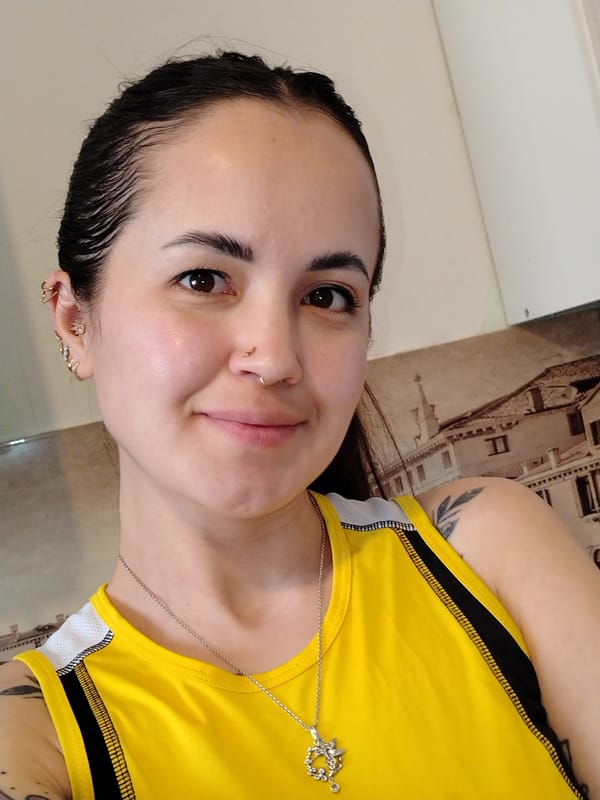 Woman takes selfie with wet hair, brown eyes visible