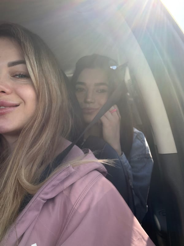 Women rest in car during confectionery shopping trip
