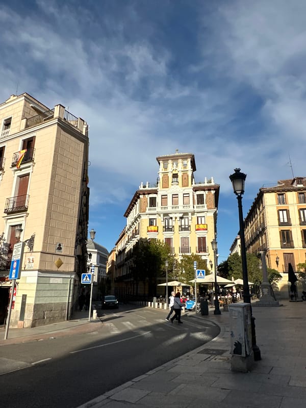 Tourist documents historic Madrid landmarks during afternoon photography walk
