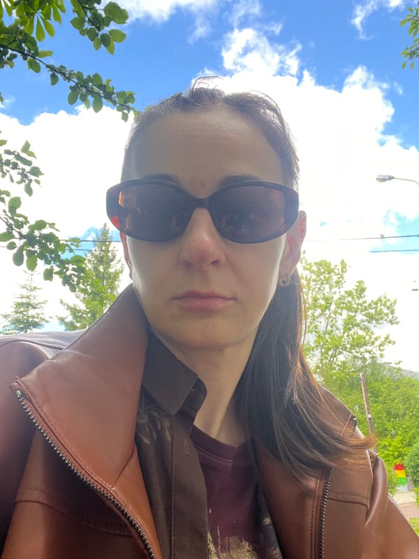 Woman takes selfies while child climbs tree in park