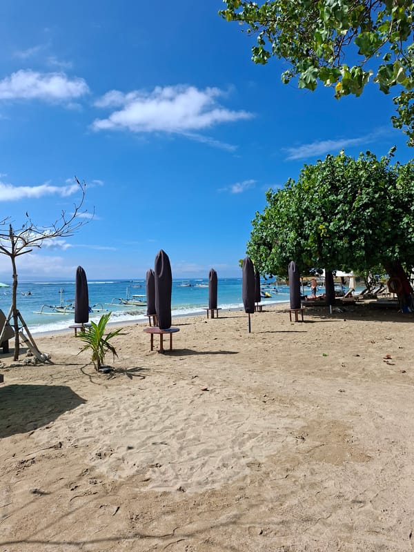 Peaceful morning beach scene documented in Denpasar, Indonesia