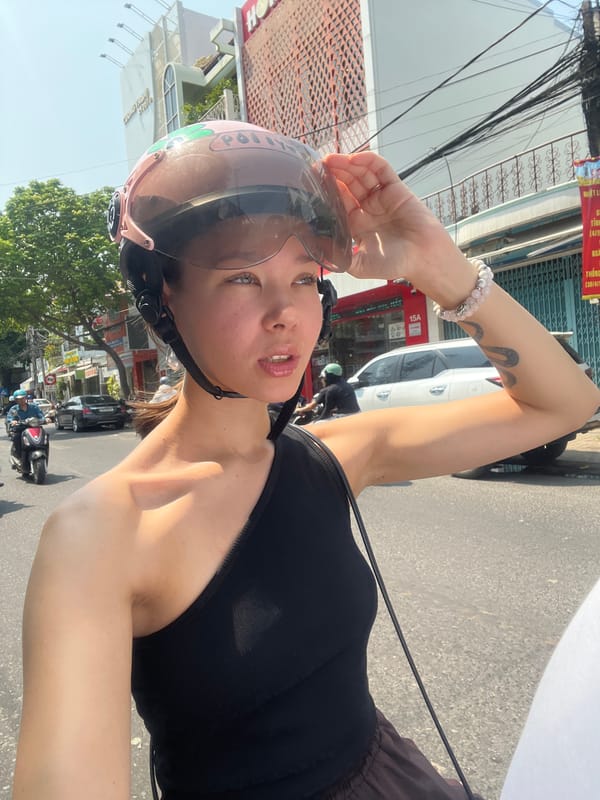 Woman takes motorcycle selfie wearing police helmet in Nha Trang