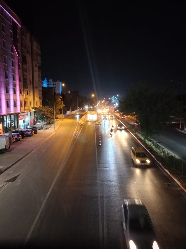 Wet night traffic near Bulvar Hotel, central Antalya
