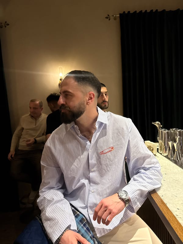 Man uses phone at Yerevan bar during evening service