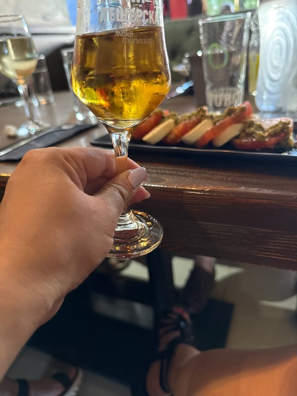 Diner enjoys drinks and Caprese salad at trendy restaurant