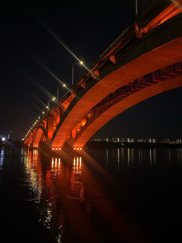Nighttime bridge views captured beneath Krasnoyarsk river crossing