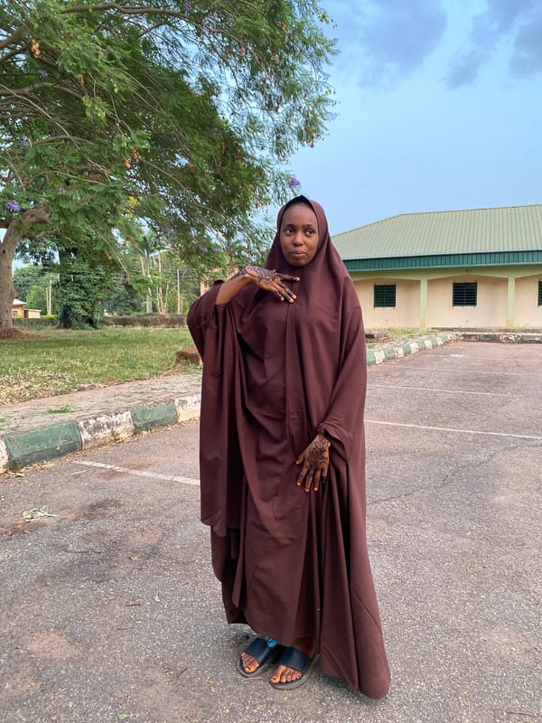Woman in lavender hijab photographed in Vom park setting