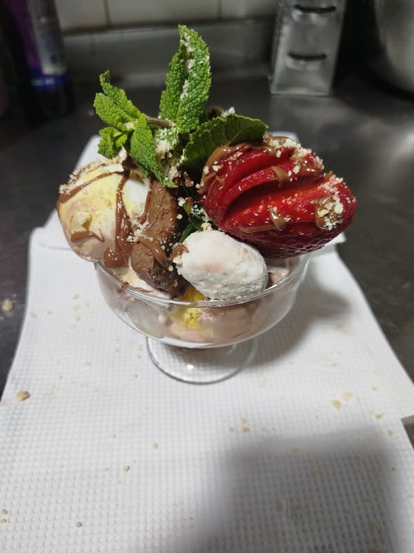 Ice cream dessert with strawberries and chocolate observed