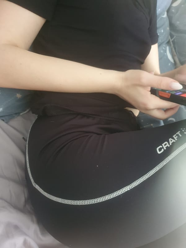Person uses smartphone on bed in Plovdiv