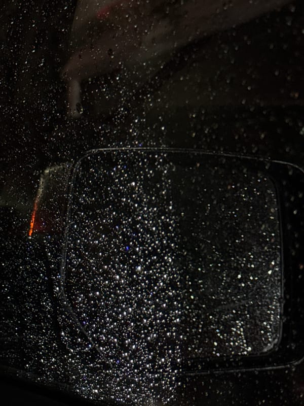 Rain-covered car mirror photographed in Mexico City