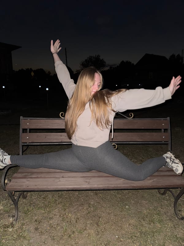 Woman performs split on bench outdoors in Russia