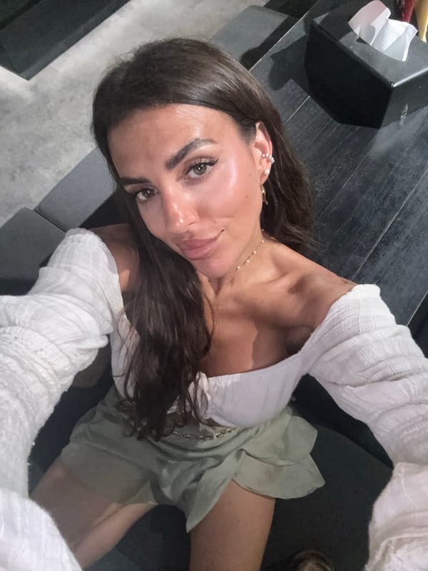 Woman takes selfies in white outfit in North Kuta