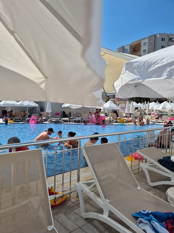 Poolside afternoon: sun, selfies, and a crowded swim session.