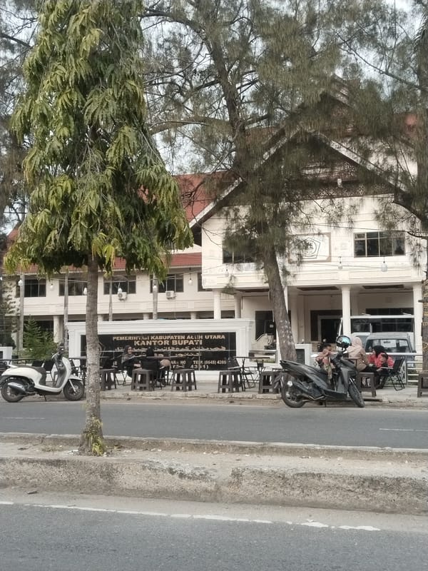 Street life near Lhokseumawe's government district on a cloudy morning