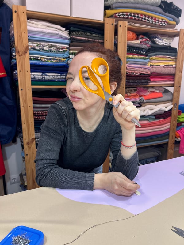 Woman works with scissors and fabrics in craft session