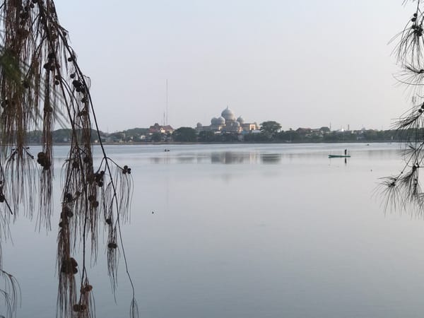 Person on boat photographed near mosque in Lhokseumawe waters