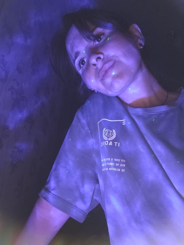 Woman with piercings photographed in dimly lit Фоки interior