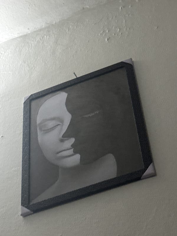 Askew portrait photograph observed on wall in Ihiagwa