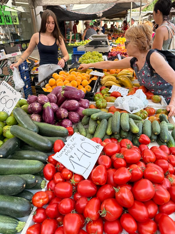 Fresh produce and pastries at a busy outdoor market