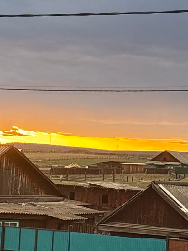 Sunset and ski storage captured in rural Zagatuy, Russia