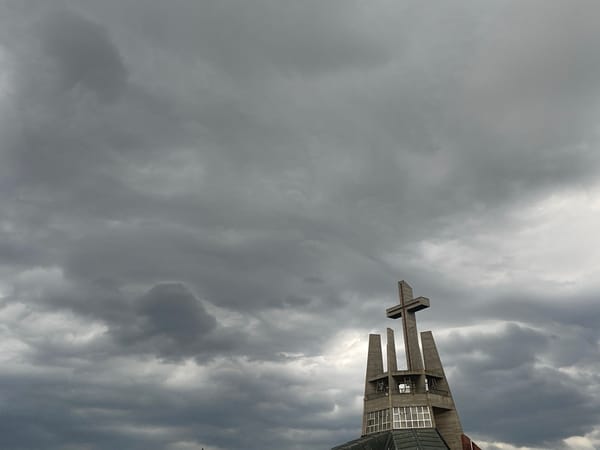 Cat naps on a Świdnica patio under cloudy skies