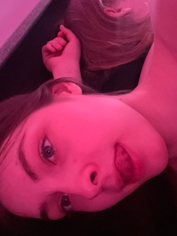 Person photographed under pink lighting in Saint Petersburg room