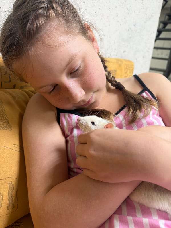 Girl bonds with pet rat in quiet moments