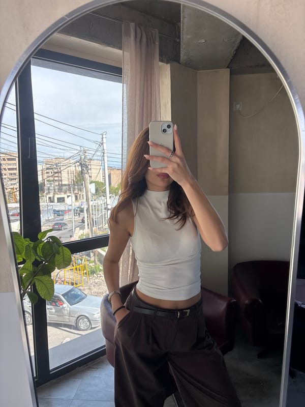 Woman takes mirror selfie indoors in Zovuni, Armenia