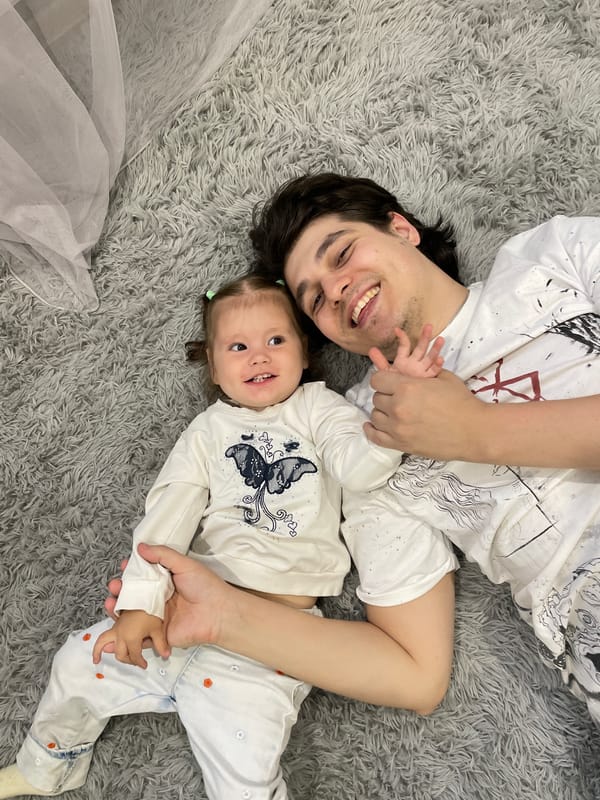 Father and child share quiet moment on rug in Izhevsk