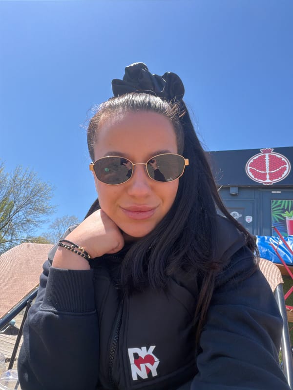 Woman in NY jacket visits beach and outdoor locations