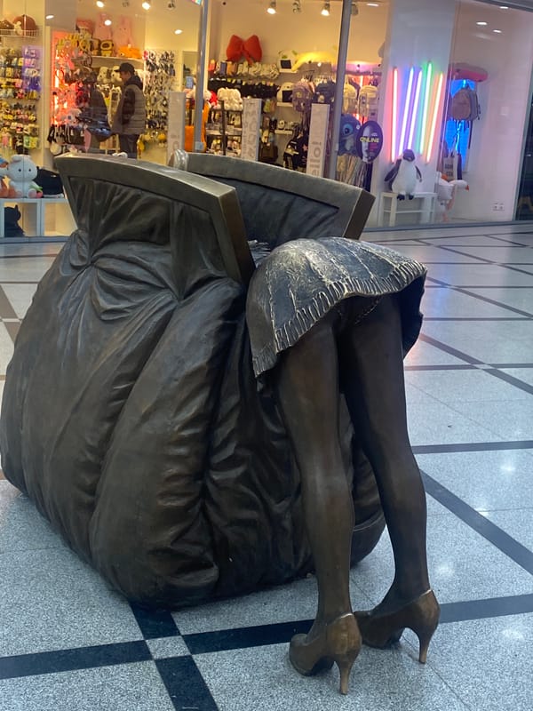 Bronze sculptures and vintage truck display in Yekaterinburg mall