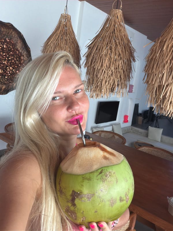 Woman drinks coconut water in Mengwi, Indonesia
