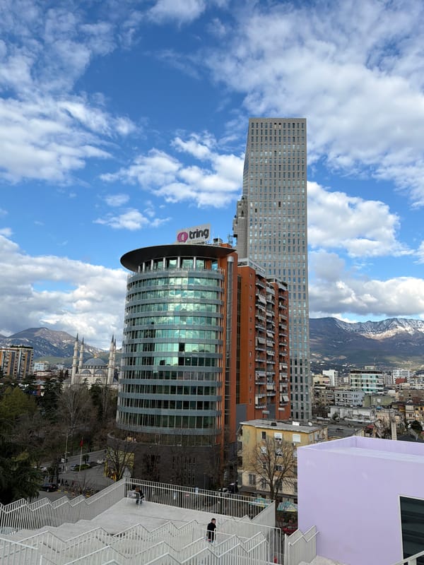 Tourists explore Tirana's rooftops, churches, and art installations