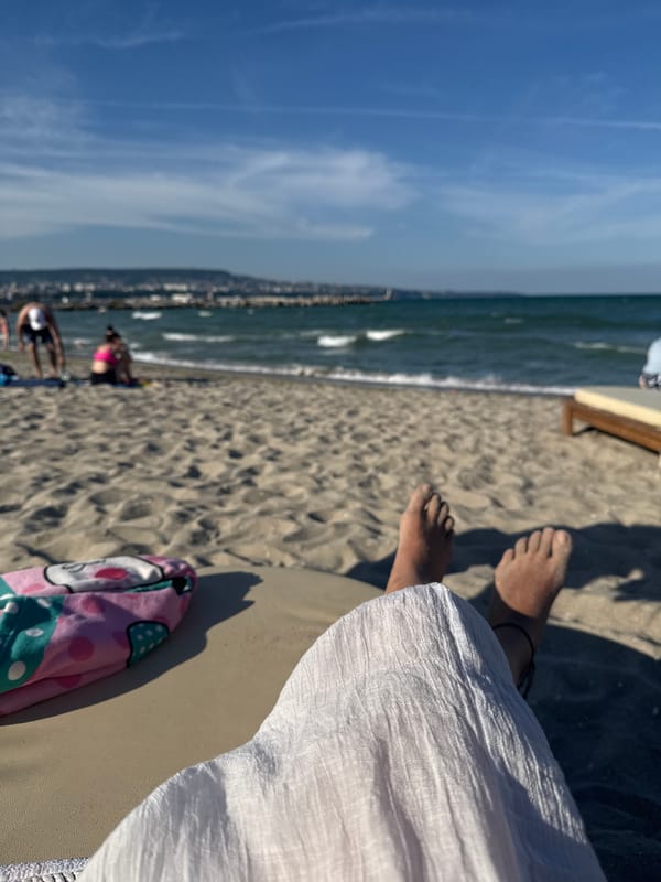 Lazy afternoon at the beach, feet in the sand and surf