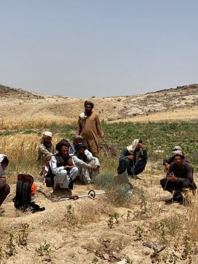 Rural gathering of men and child in agricultural area