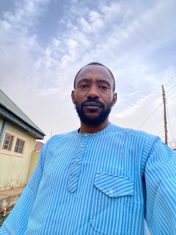Man photographed in blue striped shirt in Sabon Tasha