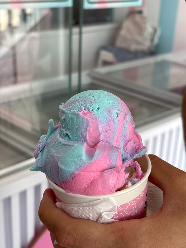 Person enjoys colorful ice cream in Santa Clara Ocoyucan