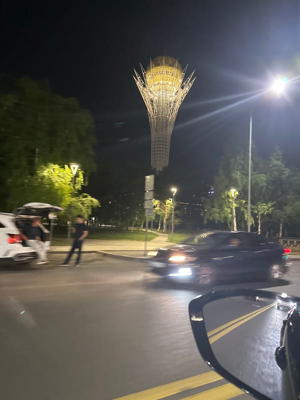Bayterek Tower glowing gold against the Astana night sky