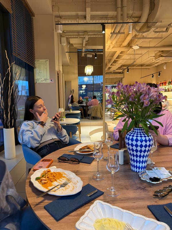 Group dining captured at Khimki restaurant during evening hours