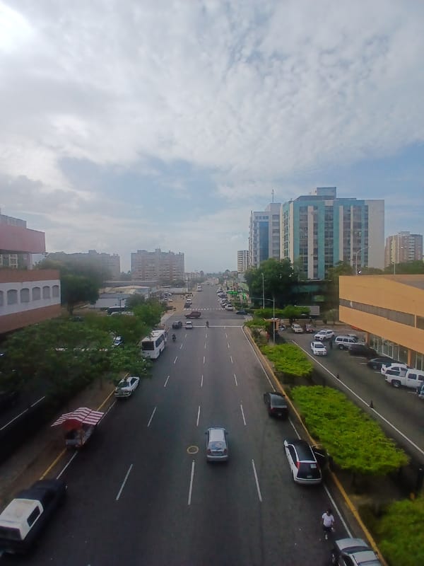 Elevated view captures Ciudad Guayana street scene under cloudy skies