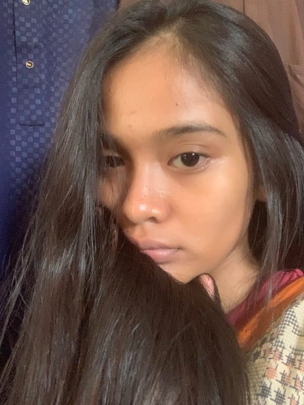 Woman photographed in casual indoor setting in Indonesian village